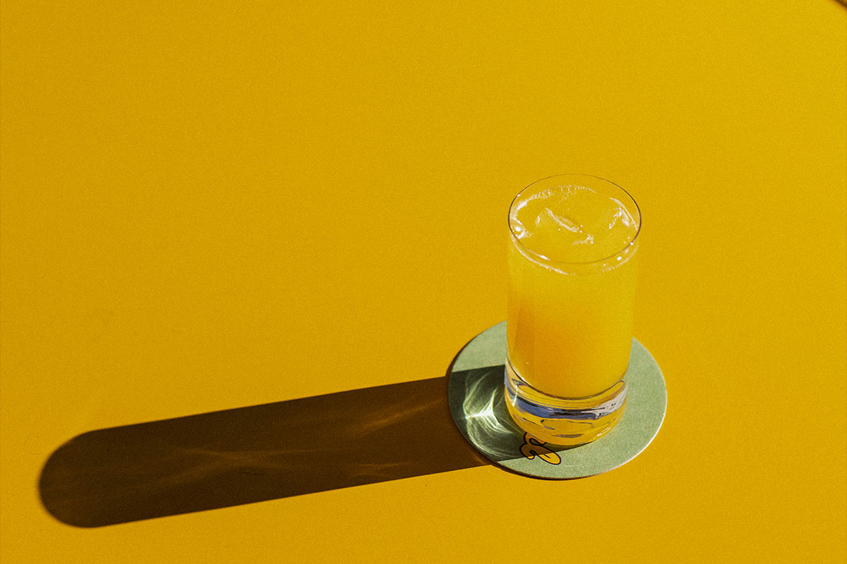 O Palmeiral terrace during golden hour — aperitivo drinks on the table, evening light on Travessa de São José, Príncipe Real, Lisbon