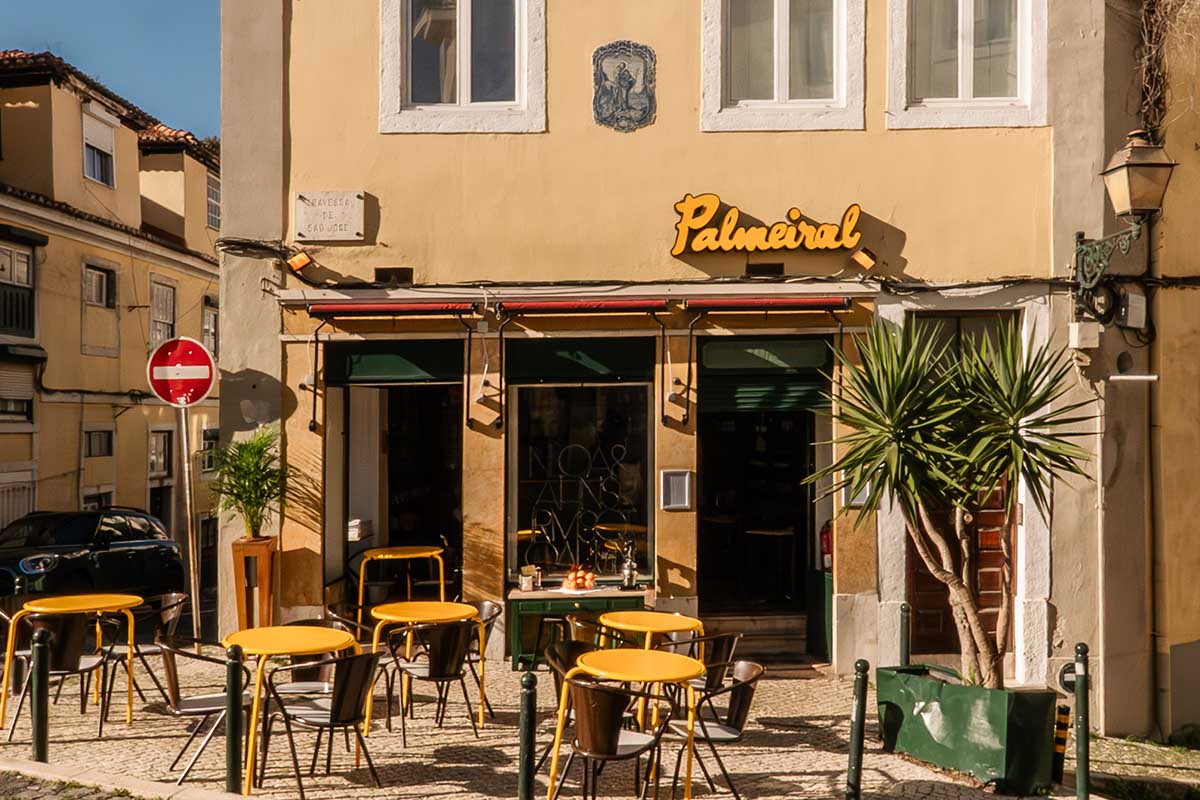 The bar and backbar of O Palmeiral restaurant in Príncipe Real, Lisbon — original wooden counter from the 1870s grocery shop